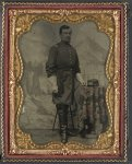 [Unidentified soldier in Union captain's uniform with U.S. Medical Service hat in front of painted backdrop showing landscape]