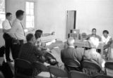 Richard Boone and Idessa Williams seated at a table in front of journalists during a press conference in Montgomery, Alabama.