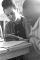 Young woman helping a seventh-grade girl with school work in the basement of St. Paul's Lutheran Church in Birmingham, Alabama.