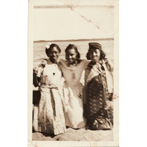 Inez Irving Hunter and two friends kneel in the sand