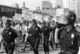 Police officers and marchers at a United Klans of America march and rally in Mobile, Alabama.