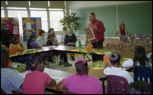 Man with Drawing Speaking to Gates Elementary Classroom