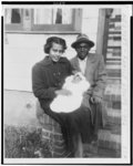 [Elizabeth and Arthur Rose, Sr., in Queens, NY, holding their baby daughter Patricia Anne and sitting on steps outside the home of sister, Lucille Banks]