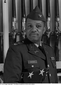 Colonel Joe D. Sasser posing with drill rifles #2