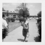 Mississippi State Sovereignty Commission photograph of an African American woman walking on a sidewalk during a training session for COFO volunteers in Oxford, Ohio, 1964