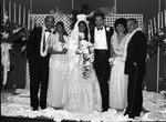 Mr. and Mrs. Andrews posing with members of their wedding party, Los Angeles, 1989