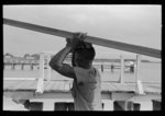 [Untitled photo, possibly related to: Negro stevedore handling lumber in unloading process, Pilottown, Louisiana, the "El Rito"]