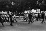 Police escort marchers at a United Klans of America march in Mobile, Alabama.