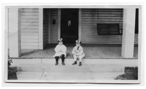 Two Children Sitting on a Porch