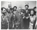 Richard J. Daley speaking at a microphone at a "We Care" event