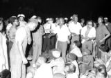 Edward Rudolph, Richard Boone, Dan Houser, Lula Williams, and others, sitting and standing on a street in downtown Montgomery, Alabama, during a civil rights demonstration.