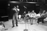 Etheridge Knight: Oxford, Miss. Knight performing at microphone in front of small audience (EKP 2-79-12/11 #295)