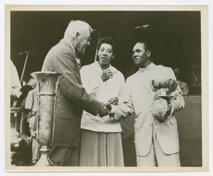 Photograph of Althea Gibson standing next to two men shaking hands