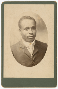 Photograph of a man wearing a suit and necktie