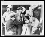 Dallas County Sheriff Jim Clark points a billy club and electric prod as he tells Negro voting demonstrators to move from in front of the Dallas Courthouse