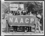 [People marching with signs to protest segregation in education at the college and secondary levels]