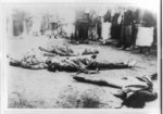 [Executed communists lying in street in Canton or Kowloon, China]