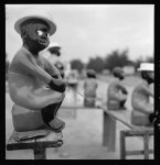 [Painted wooden statue depicting an African American man holding a fishing pole]