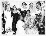 Woman placing ribbon on necklace of Stella A. Vick