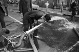 Man drinking water from a fire hose during the Children's Crusade in Birmingham, Alabama.