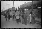 Day laborers being hired for cotton picking on Mississippi and Arkansas plantations. Between four and six-thirty every morning during the season, near the Hallan Bridge in Memphis, Tennessee, crowds of Negroes in the streets gather and are loaded into trucks by drivers who bid, and offer them anywhere from fifty cents to one dollar per day