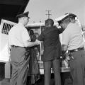 Police officers arresting Charles Butler after the Freedom Riders arrived at the Greyhound station in Birmingham, Alabama.