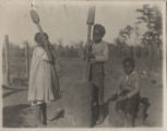 Children grinding rice.