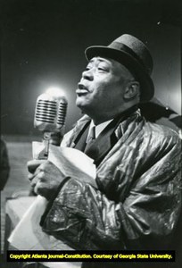 Rev. William Holmes Borders, Sr., influential leader of the Wheat Street Baptist CHurch, Atlanta, Georgia, December 1960. Here, he is seen holding a microphone.