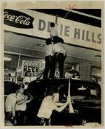 Police men climbing to the roof of a store during the Dixie Hills Riot, Atlanta, Georgia, June 20, 1967.