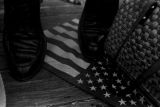 American flag beneath the feet of a man on a platform in front of the state capitol in Jackson, Mississippi, at the end of the "March Against Fear" begun by James Meredith.