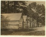 The negro berry pickers shacks on the farm of Col. J. J. Ross, Del. The interior of these shacks consists of a flooring of straw, a few bags, and absence of light and air.  Location: Ross, Delaware.