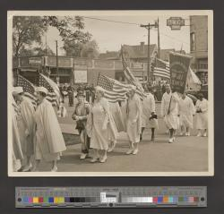 Women holding American flags in a parade