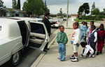 Reggie Crowder and others entering a limousine, Los Angeles