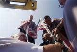 Firemen L. C. Brown, S. L. McAdams, and Lieutenant S. J. Elliott securing an American flag on an engine at Fire Station #12 in Birmingham, Alabama, after observing a moment of silence honoring the victims of the September 11 terrorist attacks.