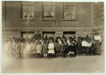 The lone teacher in charge of a room where 123 Kindergarten and First Grade children are enrolled. Dunbar School. Teacher said: "There are only 70 here to-day. There must be an epidemic around." Principal in background. See Bliss report.  Location: Muskogee, Oklahoma