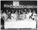 Members of the Rhododendron Club standing next to banquet table