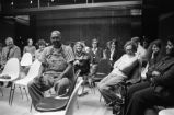 Etheridge Knight: Oxford, Miss. Knight performing at microphone in front of small audience (EKP 2-79-12/11 #295)