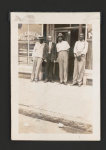 [Raymond Parks standing, second from left, with three men, in front of the "Atlas Barber &amp; Beauty" shop, Montgomery, Alabama, where he worked as a barber]