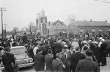 Civil rights demonstrators, journalists, and law enforcement officials gathered on Sylvan Street in front of Brown Chapel AME Church in Selma, Alabama.