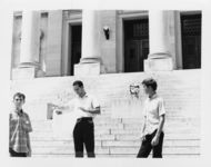 Mississippi State Sovereignty Commission photograph of Richard Barrett holding a proclamation and standing between two teenage boys on the steps of the Mississippi State Capitol during a demonstration, Jackson, Mississippi, 1967 July 30