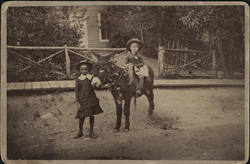 Two children with a burro