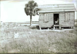 African-American woman in doorway of cabin