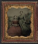 [Two unidentified young women wearing printed dresses and necklaces in front of painted backdrop showing plantation]