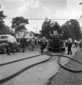 Firemen removing hoses from an engine during a civil rights demonstration in Talladega, Alabama.