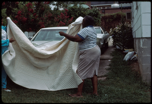 Fabric arts: Ruby Merritt. Tanya Frazier (left) and Ruby Merritt place one of Merritt's quilts on the car.