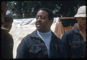 Rev. Ralph Abernathy walking through the Resurrection City encampment