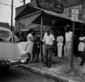 Juanita Jones hugging her sister, Maxine McNair, in front of Social Cleaners across from 16th Street Baptist Church, after the church was bombed.