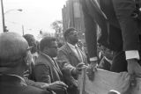 James Orange and others behind the cart carrying Martin Luther King, Jr.'s casket during the funeral procession.