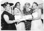 Four women holding "This is your life Stella A. Vick June 10, 1956" album