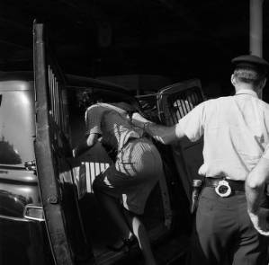 Police officers arresting Lucretia Collins after the Freedom Riders arrived at the Greyhound station in Birmingham, Alabama.